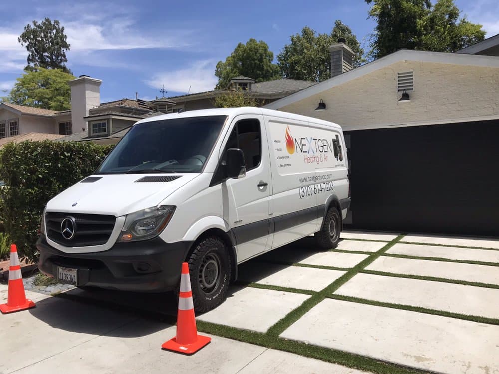 NextGen's wrapped Sprinter van parked in a client's driveway on a sunny Valley street